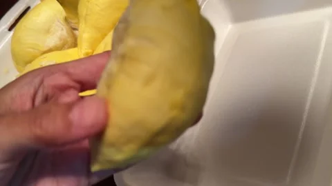 Hands Separating Durian Flesh From Seed Stock Footage 336708928