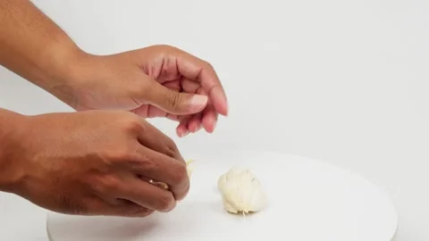 Hands Separating Garlic Cloves for Cooking Preparation Stock Footage 327849260