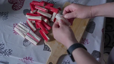 Hands Separating Surimi Sticks Before Food Preparation Stock Footage 341766787