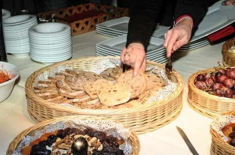 Hands Serving Artisan Bread at a Festive Buffet Stock Photos