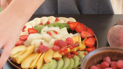 Hands serving fruit and berry plate . Video stock 77082843
