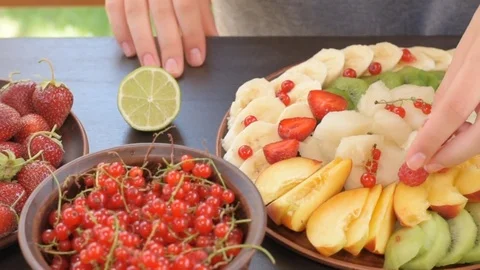 Hands serving fruit and berry plate . Stock Footage 77082996