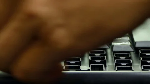 Hands set the desired buttons into the slots of the keyboard. Stock-Footage 85076643