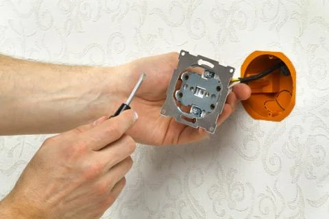 Hands set the electrical outlet Stock Photos