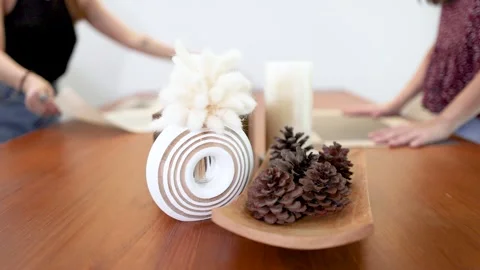 Hands Setting a Minimalist Dining Table with Pine Cones and Placemats 스톡 동영상 335738663