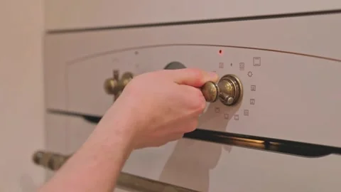 Hands setting the mode and temperature, adjusting the oven before baking Video stock 324883329
