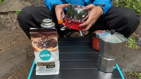Hands Setting Up Portable Stove for Coffee Brewing, Outdoor Camping, Close-Up Stock Footage 324851207