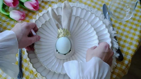 Hands setting table for Easter Stock Footage 332702033