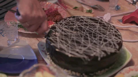 Hands severs sweet  cake by knife and put piece on plate, close-up view Stock Footage 58479564