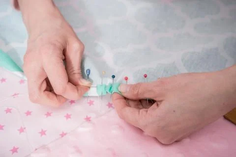 Hands sew clothes Stock Photos