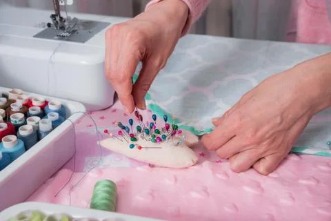 Hands sew clothes Stock Photos