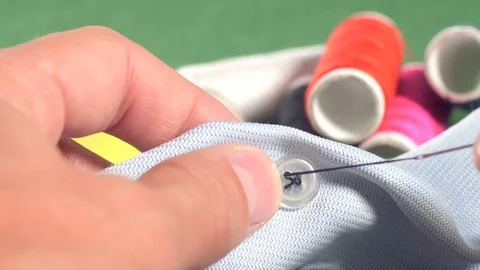 Hands sewing on button 库存影片 70748294