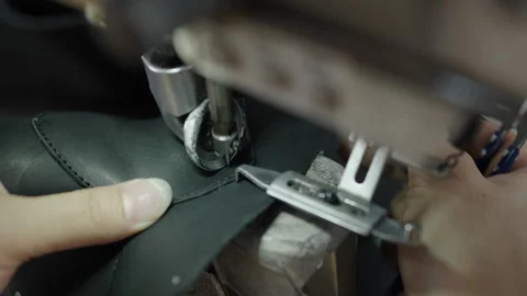 Hands Sewing Leather Shoe Upper with Industrial Machine in Workshop Close Up Stock Footage 341668957