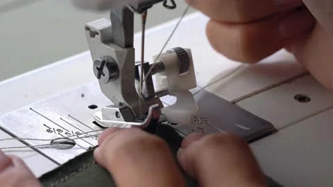 Hands at sewing machine holding some fabric Stock Footage 169793429
