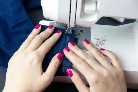 Hands on the sewing machine Stock Photos