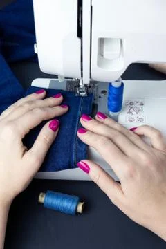 Hands on the sewing machine Stock Photos