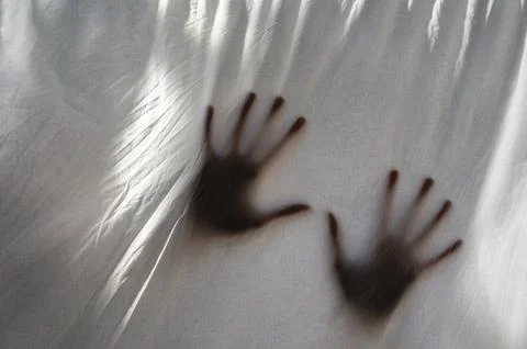 Hands shade behind sheet Stock Photos