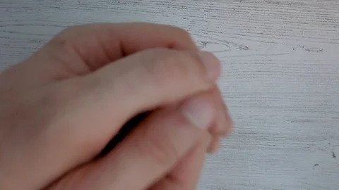 Hands shake a 6 sided die and roll a one. Single black die on white backgroun 動画素材 115009498