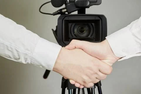 Hands shaking in front of a video camera, public contract,  public assurances Stock Photos