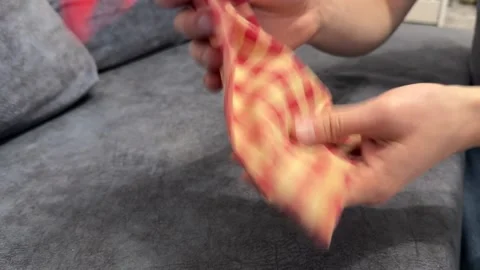 Hands shaking a small fabric bag with game pieces inside. Close up of mixing Stock Footage 336976808