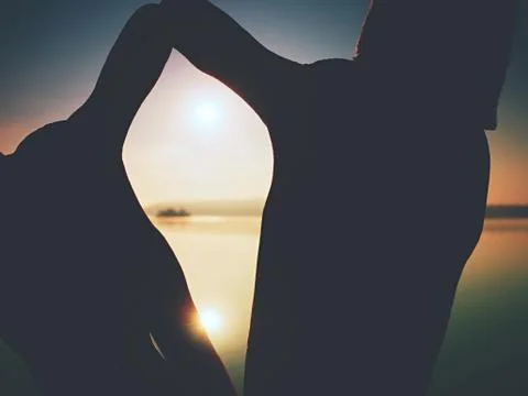 Hands in the shape of frame against  Sun. Shadow play over sea Stock Photos