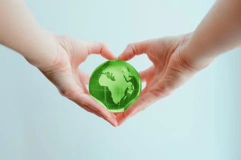 Hands in shape of heart  holding green glass globe of Africa and Europe Stock Photos