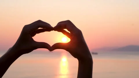 Hands Shape Heart Over the Sunset by the Ocean or Sea. Silhouette Close up Stock Footage 159726282