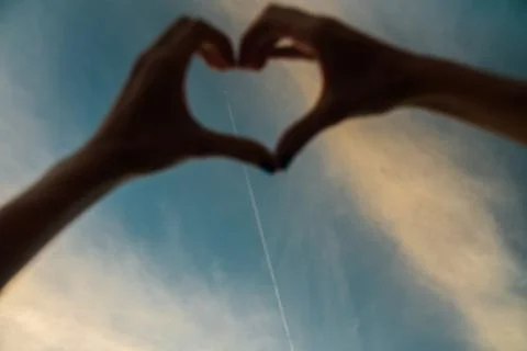 Hands in shape of love heart Stock Photos