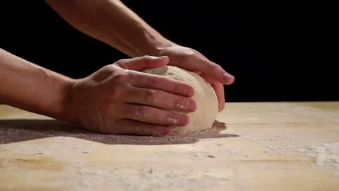 Hands Shaping and Kneading Dough In Slow Motion On Black Background Stock Footage 82149643