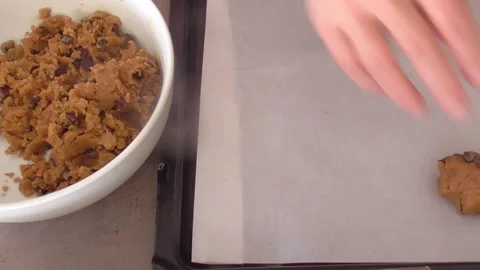 Hands Shaping Chocolate Chip Cookie Dough on Baking Tray Stock Footage 346127268