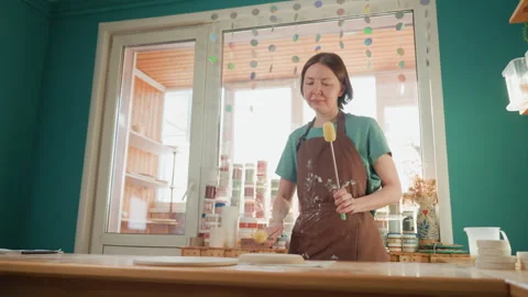 Hands shaping clay with tools. Craftsperson delicately refining textured ceramic Stock Footage 342283321