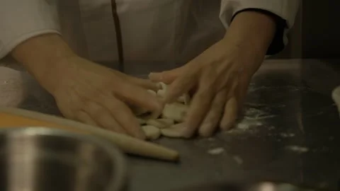 Hands Shaping Dough Pieces for Dumplings on Floured Surface in Beijing Kitchen Stock Footage 345880207