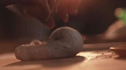 Hands shaping dough into round loaf for baking bread and rolls. Baker working Stock Footage 344844527