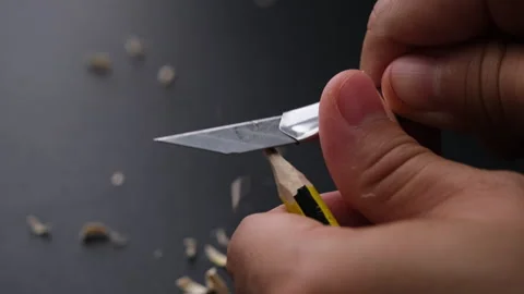 Hands sharpening pencil using utility knife, close up. Stock Footage 248504066