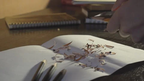 Hands sharpening a simple pencil with a knife close up Stock Footage 160618229