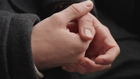 Hands shift silently. Subtle hand gestures reflect inner contemplation Stock Footage 345165522