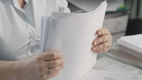 Hands shift a stack of documents Video stock 87912654