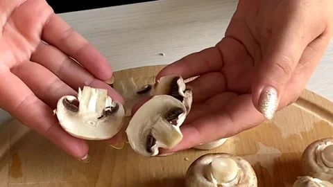 Hands show cut champignons. Cooking pizza Stock Footage 159764778