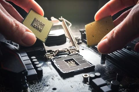Hands show different processors. Two CPUs against the background of the Stock Photos