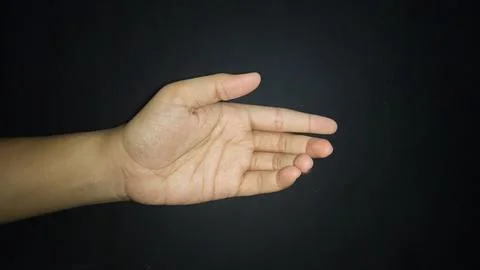 Hands show a gesture of giving help. Isolated on black background Stock Photos