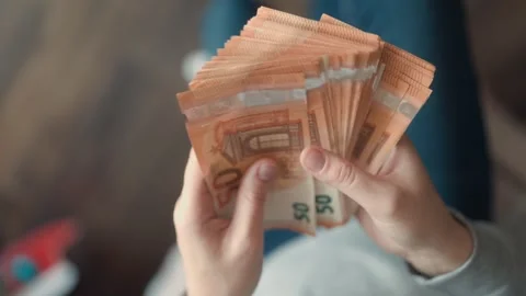 Hands showcasing euro banknotes, symbolizing monetary prosperity and security. Stock Footage 304814606
