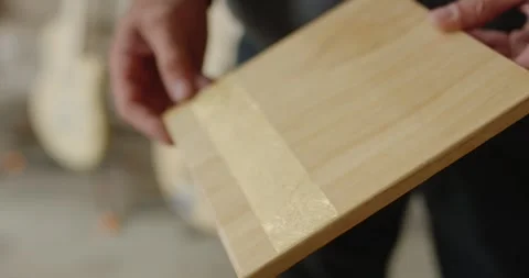 Hands Showing Gold Leaf Stripe on Wooden Board, Gilded Surface Detail, Close Up Vídeo Stock 340326742