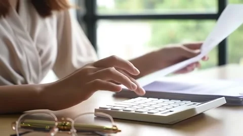 Hands Shuffling Papers and Pressing Calculator Buttons. Stock Footage 316877641