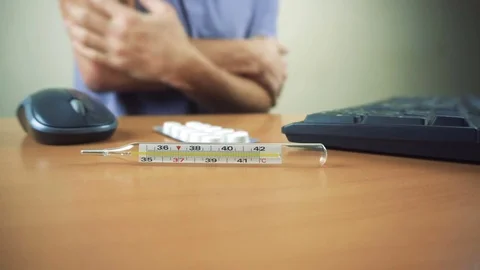 Hands of sick man typing on keyboard and working in office Stock Footage 83432584