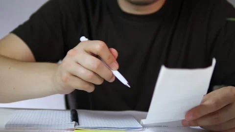 Hands sift through formal balance sheets, searching for specific financial data 스톡 동영상 316220207
