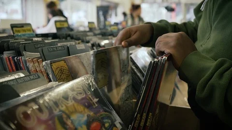 Hands Sifting and Sorting Through Records at a Vintage Music Shop Stock Footage 123344732