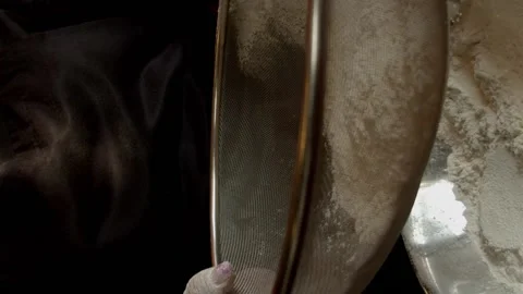 Hands sifting flour in a plate Stock Footage 135377873