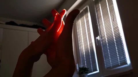 Hands Silhouetted Against Window Light, Gentle Movement Stock Footage 327125190