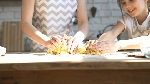 Hands of sisters kneading dough at the kitchen. Stock Footage 106236964