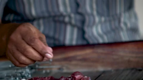 Hands skewering raw mutton meat pieces on metal bicycle spokes to prepare t.. Stock Footage 344804578